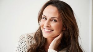 a woman is smiling | Feature | Are Pandemic Restrictions Changing The Epigenetic Regulation of Your Skin?