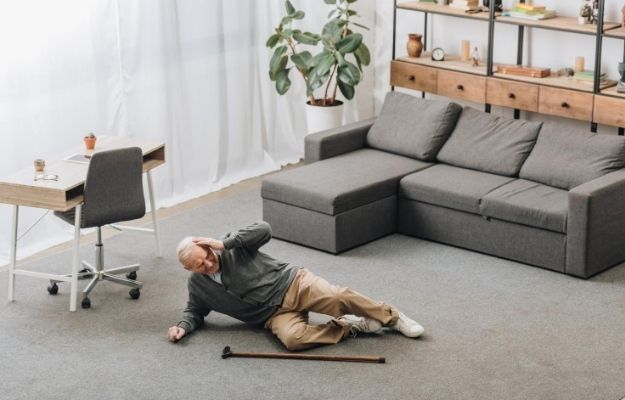 An old man is falling down with the sofa behind | This Cellular Respiration Compound May Ease Parkinson's Symptoms, Study Suggests