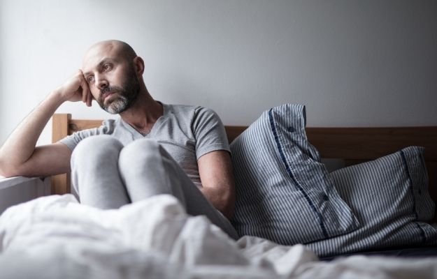 a man is feeling sad sitting on the bed | What Is Autism? | Researchers Discover DNA in Umbilical Cord Can Diagnose Autism Early