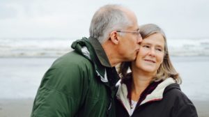 an old couple having a kiss on the beach | Feature | Epigenetics And Aging: How Some People Are Able To Age Better
