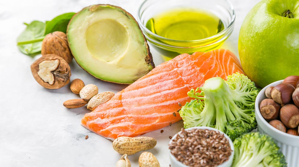 Dish of ketogenic diet with salmon, broccoli, avocado and olive oil | Feature | Ketogenic Diet Duration and Exercise Impacts on Gene Expressions