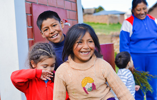 A group of Latin children having fun at school | Blog - Socioeconomic Disadvantage Accelerates Biological Aging in Children