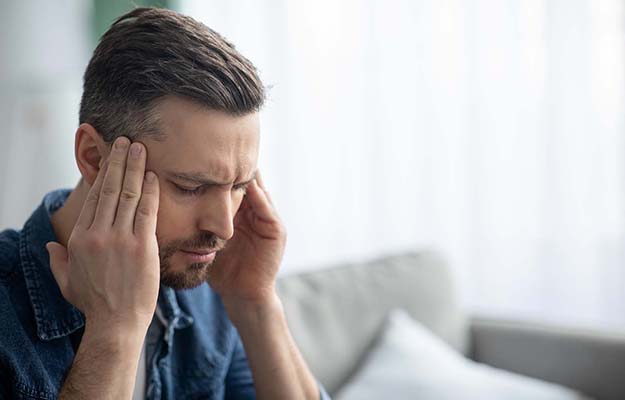 man having headace and rubbing his temples | Does a Migraine Diet Rich in Folate Really Work, and Can It Be Classed as Epigenetic?